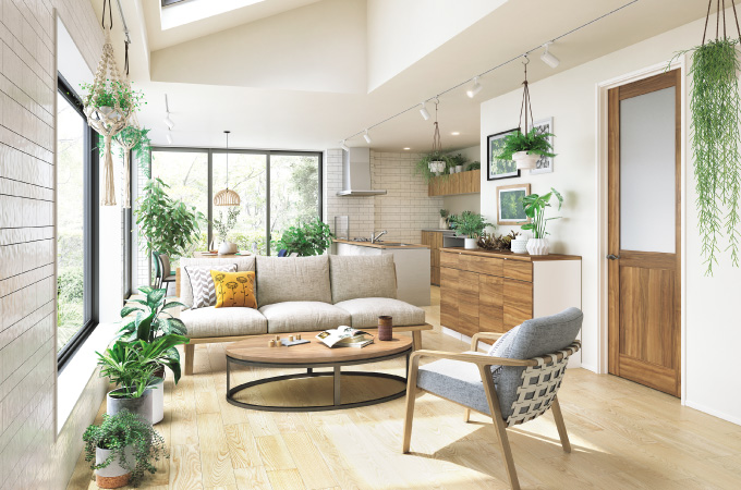 ベージュのフローリングとベージュの家具でナチュラルテイストの空間に観葉植物が映えるリビング画像