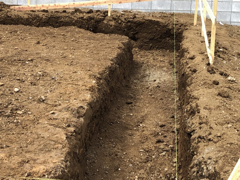 日高市新築戸建て住宅根切作業で地面に穴を掘っています